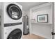 Compact laundry room with a stacked washer and dryer at 4211 S Peninsula Dr, Port Orange, FL 32127