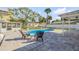 Relaxing pool area with two lounge chairs, a small table, and pavers at 4211 S Peninsula Dr, Port Orange, FL 32127