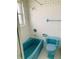 Blue bathroom with bathtub, toilet, and window at 4255 S Atlantic Ave, Port Orange, FL 32127