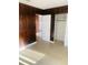 Bedroom with wood paneling, closet, and carpet at 4255 S Atlantic Ave, Port Orange, FL 32127