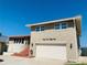Tan two-story house with attached garage and ocean view at 4255 S Atlantic Ave, Port Orange, FL 32127