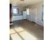 Living room with kitchen access and speckled floor at 4255 S Atlantic Ave, Port Orange, FL 32127
