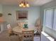 Condo dining area with round table and four chairs at 4501 S Atlantic Ave # 1150, New Smyrna Beach, FL 32169