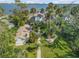 Aerial view of waterfront property with lush landscaping at 4946 Halifax Dr, Port Orange, FL 32127