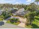 Aerial view of two-story home with circular driveway and lush landscaping at 4946 Halifax Dr, Port Orange, FL 32127