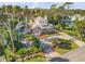 Drone view showcasing a charming waterfront home with a pool and gated entrance at 4946 Halifax Dr, Port Orange, FL 32127