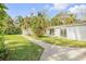 Landscaped backyard with a path, studio and lawn at 4946 Halifax Dr, Port Orange, FL 32127