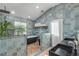 Spa-like bathroom with a freestanding tub, walk-in shower, and blue tile at 4946 Halifax Dr, Port Orange, FL 32127