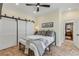 Charming bedroom with metal bed frame and barn doors at 4946 Halifax Dr, Port Orange, FL 32127
