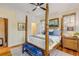 Main bedroom with a wooden four-poster bed and built-in cabinets at 4946 Halifax Dr, Port Orange, FL 32127