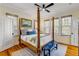 Bedroom with four-poster bed, artwork, and hardwood floors at 4946 Halifax Dr, Port Orange, FL 32127