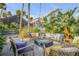 Charming fire pit with comfortable seating nestled in tropical plants at 4946 Halifax Dr, Port Orange, FL 32127