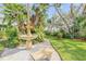 Landscaped garden with a stone fountain and a wooden bench at 4946 Halifax Dr, Port Orange, FL 32127