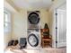 Laundry room with stacked washer and dryer, plus extra storage at 4946 Halifax Dr, Port Orange, FL 32127