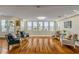 Spacious living room with hardwood floors, large windows, and water views at 4946 Halifax Dr, Port Orange, FL 32127