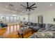 Spacious living room with hardwood floors, large windows, and comfortable seating at 4946 Halifax Dr, Port Orange, FL 32127