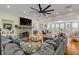 Living room with stone fireplace, sectional sofa, and hardwood floors at 4946 Halifax Dr, Port Orange, FL 32127