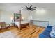 Main bedroom with hardwood floors, four-poster bed, and access to a balcony at 4946 Halifax Dr, Port Orange, FL 32127