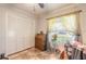 A bedroom featuring tiled flooring, closet, ceiling fan, window, and basic furniture at 5583 Miles Dr, Port Orange, FL 32127