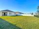 Spacious backyard with a view of the house and fence at 815 Sky Haven Way, New Smyrna Beach, FL 32168