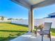 Covered patio overlooking a fenced backyard with lush grass at 815 Sky Haven Way, New Smyrna Beach, FL 32168