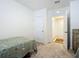 Small bedroom with carpet and access to hallway at 815 Sky Haven Way, New Smyrna Beach, FL 32168