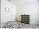 Bedroom with dresser, window, and floral bedding at 815 Sky Haven Way, New Smyrna Beach, FL 32168