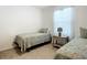 Bedroom with twin beds, nightstand, and window at 815 Sky Haven Way, New Smyrna Beach, FL 32168