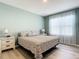 Primary bedroom with king bed and light green walls at 815 Sky Haven Way, New Smyrna Beach, FL 32168