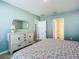 Primary bedroom with dresser, ensuite access, and flooring at 815 Sky Haven Way, New Smyrna Beach, FL 32168