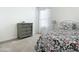 Bedroom with dresser, window, and floral bedding at 815 Sky Haven Way, New Smyrna Beach, FL 32168