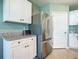 Stainless steel refrigerator and white shaker cabinets in the kitchen at 815 Sky Haven Way, New Smyrna Beach, FL 32168