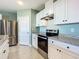 White shaker cabinets, granite counters, and stainless steel appliances at 815 Sky Haven Way, New Smyrna Beach, FL 32168