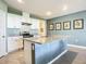 Modern kitchen with island, granite countertops, and stainless steel appliances at 815 Sky Haven Way, New Smyrna Beach, FL 32168