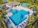 Community pool with lounge chairs and shaded areas at 815 Sky Haven Way, New Smyrna Beach, FL 32168