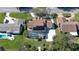 Aerial view of the home with pool, solar panels, and surrounding properties at 839 Fairway Dr, New Smyrna Beach, FL 32168