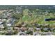 High-angle aerial view of a home near a golf course at 839 Fairway Dr, New Smyrna Beach, FL 32168