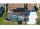 Aerial view showcasing the home's pool, solar panels, and surrounding neighborhood at 839 Fairway Dr, New Smyrna Beach, FL 32168