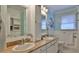 Dual vanity bathroom with light teal walls, granite countertops, and white cabinets at 839 Fairway Dr, New Smyrna Beach, FL 32168