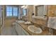 Elegant bathroom featuring double sinks, granite countertops, and a shower at 839 Fairway Dr, New Smyrna Beach, FL 32168