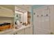 Well-lit vanity area with ample storage space and a white countertop at 839 Fairway Dr, New Smyrna Beach, FL 32168