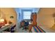 A cozy bedroom with workspace, ample natural light, and a comfortable bed at 839 Fairway Dr, New Smyrna Beach, FL 32168