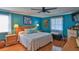 King-size bed in a teal bedroom with wooden furniture and matching decor at 839 Fairway Dr, New Smyrna Beach, FL 32168