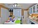 Large craft room with two work tables, abundant storage, and white cabinetry at 839 Fairway Dr, New Smyrna Beach, FL 32168