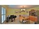 Dining room with chandelier, piano, hutch, and table with seating for six at 839 Fairway Dr, New Smyrna Beach, FL 32168