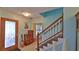Welcoming entryway with light blue walls and staircase at 839 Fairway Dr, New Smyrna Beach, FL 32168