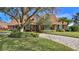 Two-story home with brick and siding exterior, driveway, and landscaped yard at 839 Fairway Dr, New Smyrna Beach, FL 32168