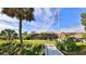 Home with private dock, flag pole, enclosed pool, and landscaped backyard at 839 Fairway Dr, New Smyrna Beach, FL 32168