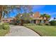 Two-story home with brick and siding exterior, driveway, and landscaped yard at 839 Fairway Dr, New Smyrna Beach, FL 32168