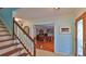 Foyer with staircase, tile floor, and view into an office at 839 Fairway Dr, New Smyrna Beach, FL 32168